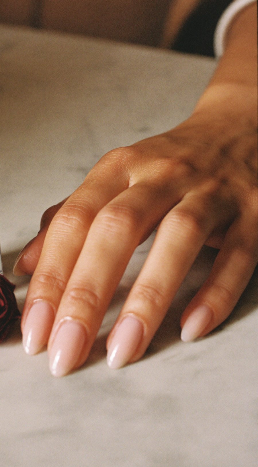 Milky nude gel nails on marble